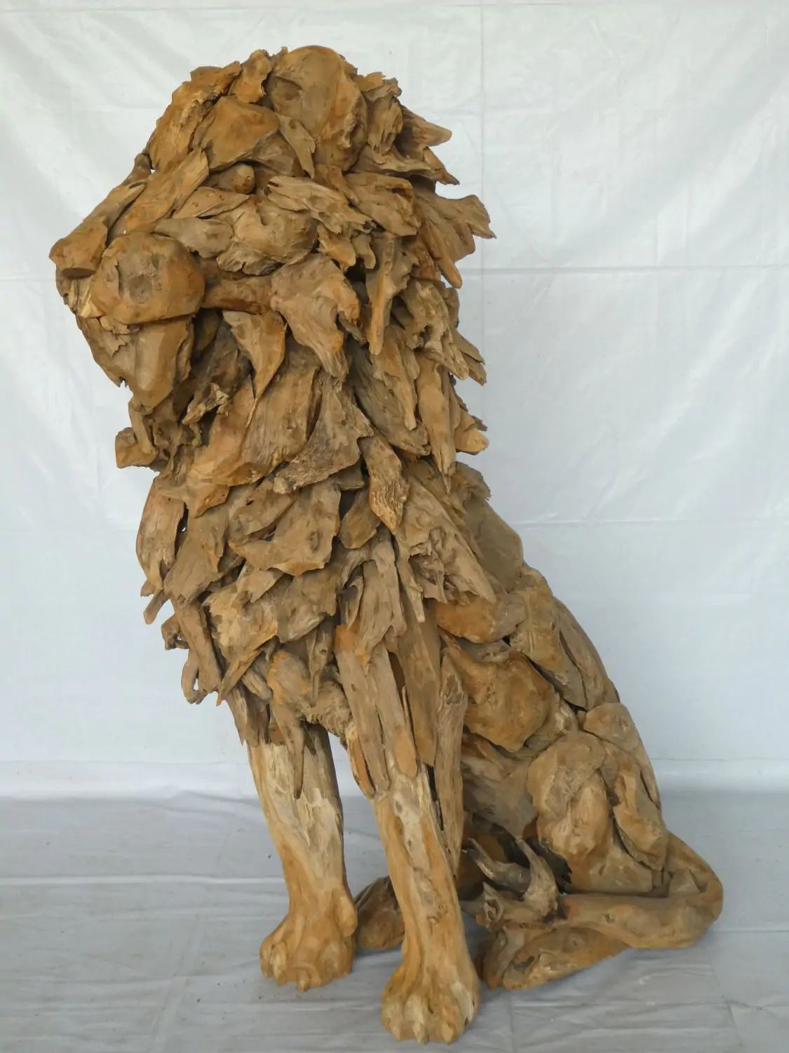  Product image 1 of the product “Seated royal Lion made from teak root pieces. About 100cm length and 150cm height. ”